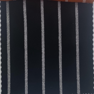 A black and white stripe on a surface with natural slubs and irregular threads, very characteristic of linen.