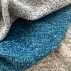 MELANGE COLOURED BRUSHED CUT & SEW FABRICS DRAPED NEXT TO EACH OTHER.