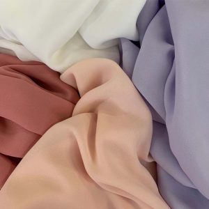 PASTEL COLOURED SHEER FABRIC DRAPED NEXT TO EACH OTHER