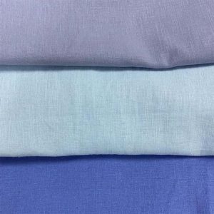 TONAL BLUE LINEN FABRICS DISPLAYED HORIZONTALLY.