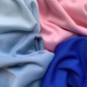 DIFFERENT COLOURED TRILOBAL FABRIC DRAPED NEXT TO EACH OTHER