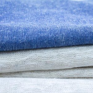 DIFFERENT COLOURED KNITTED FABRICS DISPLAYED HORIZONTALLY.